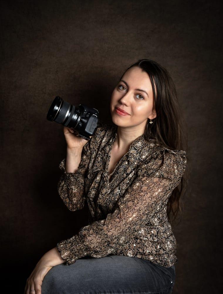 Photographe en studio, appareil à la main